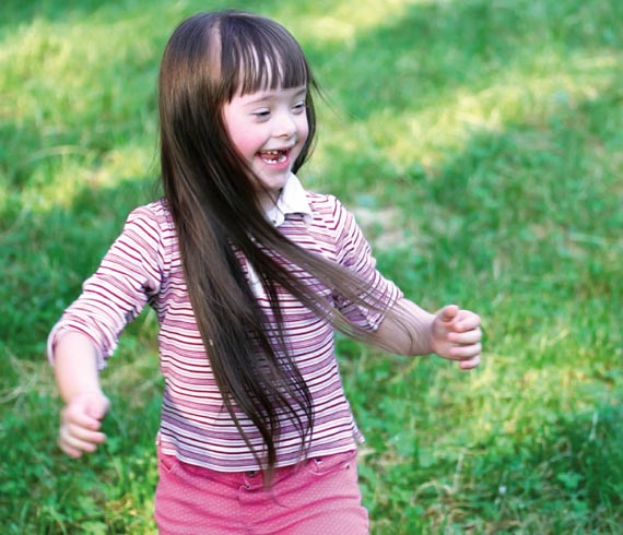 Image of smiling female child running.